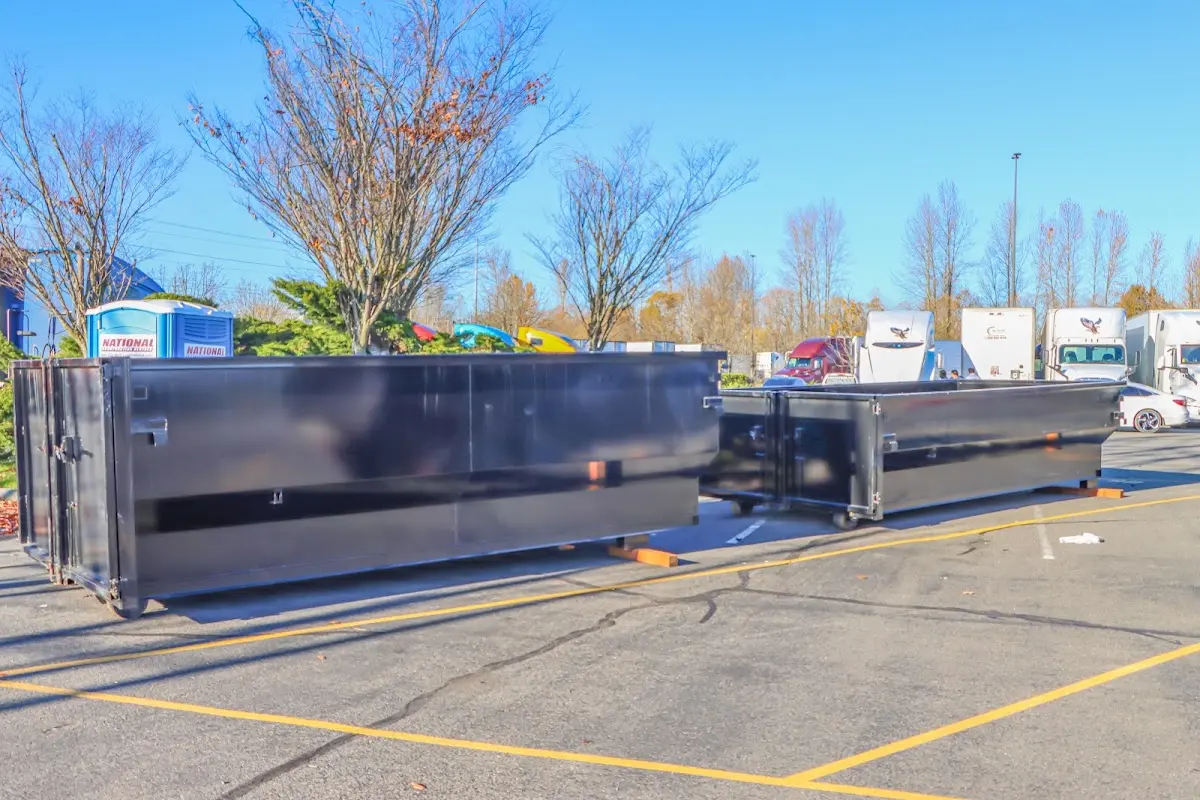 Professional dumpster rental service with roll-off container on residential driveway in Perryton